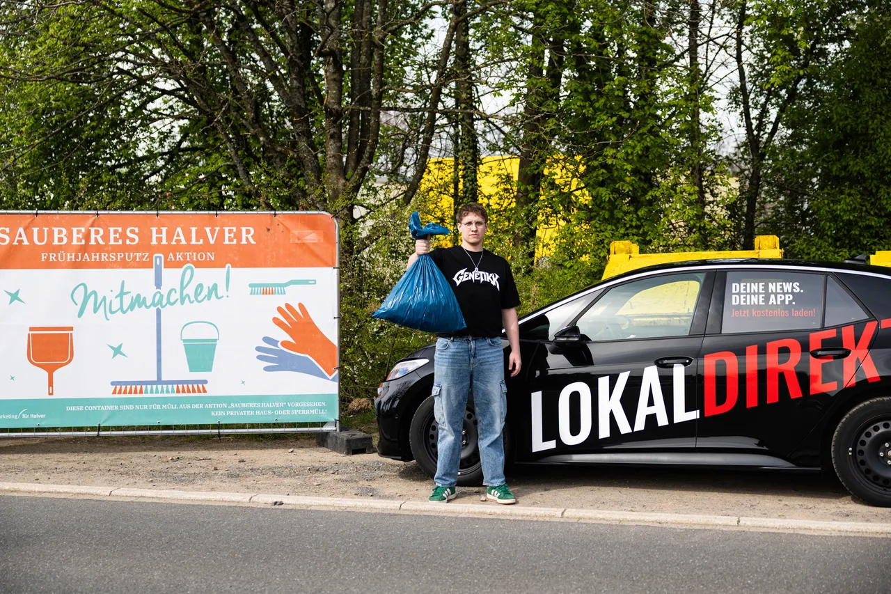 Junger Mann mit Müllsack steht neben einem Auto mit Aufschrift „LokalDirekt“ vor einem Plakat zur Müllsammelaktion „Sauberes Halver“.
