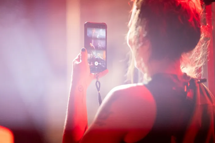 Eine Person filmt mit einem Smartphone die Turntable Stage bei Bautz 2026, auf deren Display ein Musiker zu sehen ist.