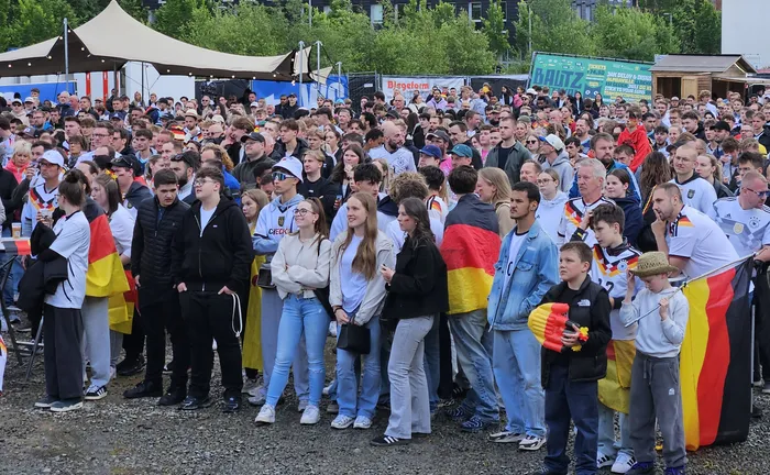 Eine große Menschenmenge jubelt, viele halten Deutschlandflaggen hoch. Die Fans feiern den Sieg der deutschen Nationalmannschaft bei der XXL-WM-Party in Lüdenscheid.