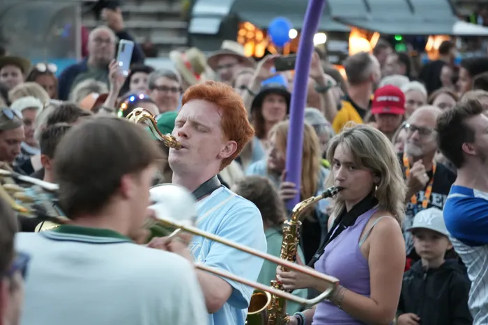 Ein rothaariger Mann spielt Trompete und eine Frau spielt Saxophon inmitten einer Menschenmenge beim Bautz 2026.