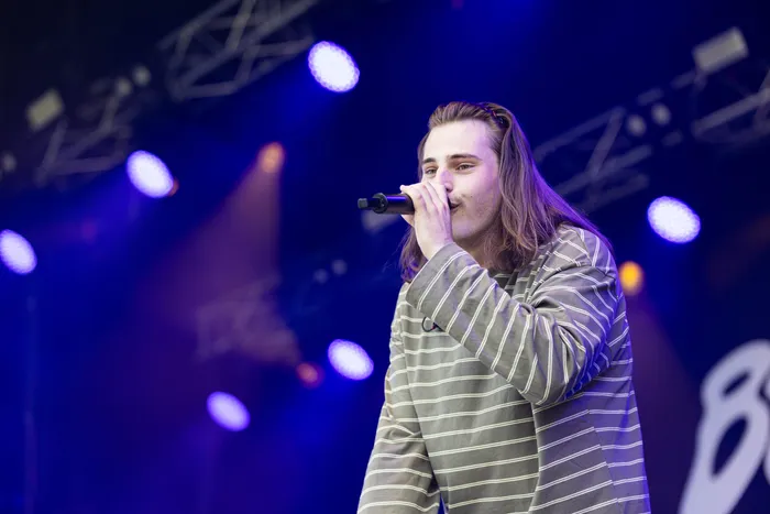 Baumgart singt in ein Mikrofon unter blauem Bühnenlicht auf dem Bautz-Festival 2026.