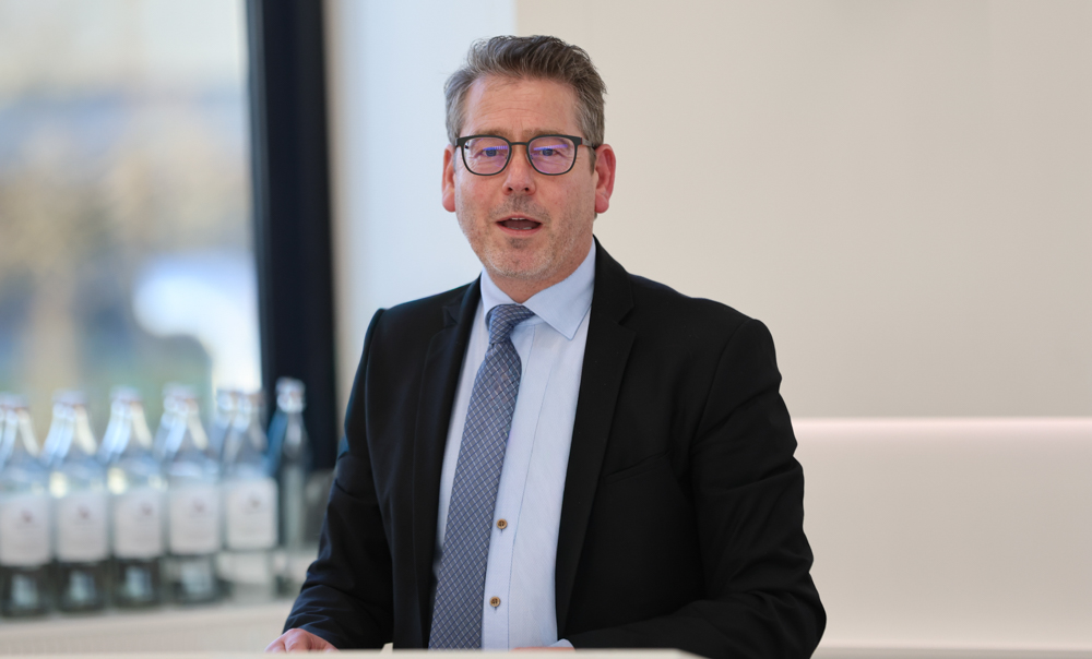 Karsten Meininghaus, CDU-Politiker mit Brille und Anzug, spricht in einer hellen Umgebung.