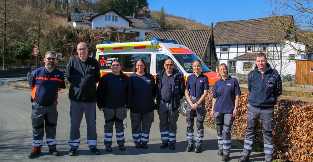 Acht ehrenamtliche Helfer des Deutschen Roten Kreuzes Balve stehen vor einem Rettungswagen. Von links sind Matthias Maslow, Meinhard Hahn, Kim Haaser, Nancy Haaser, René Haaser, Carlotta Mühling, Tanja Hauck und Julian Krämer zu sehen.
