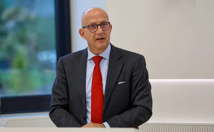 Landrat Ralf Schwarzkopf mit Brille, dunklem Anzug und roter Krawatte spricht.
