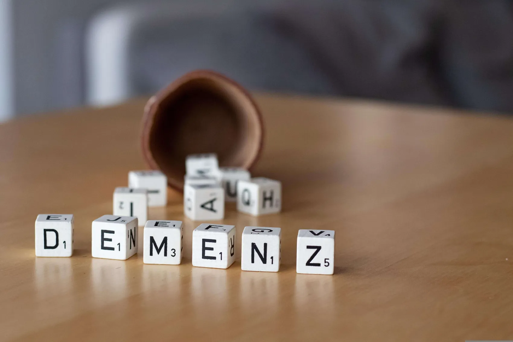 Buchstabenwürfel mit der Aufschrift „Demenz“ auf einer Oberfläche. Symbolbild für die Krankheit Demenz.